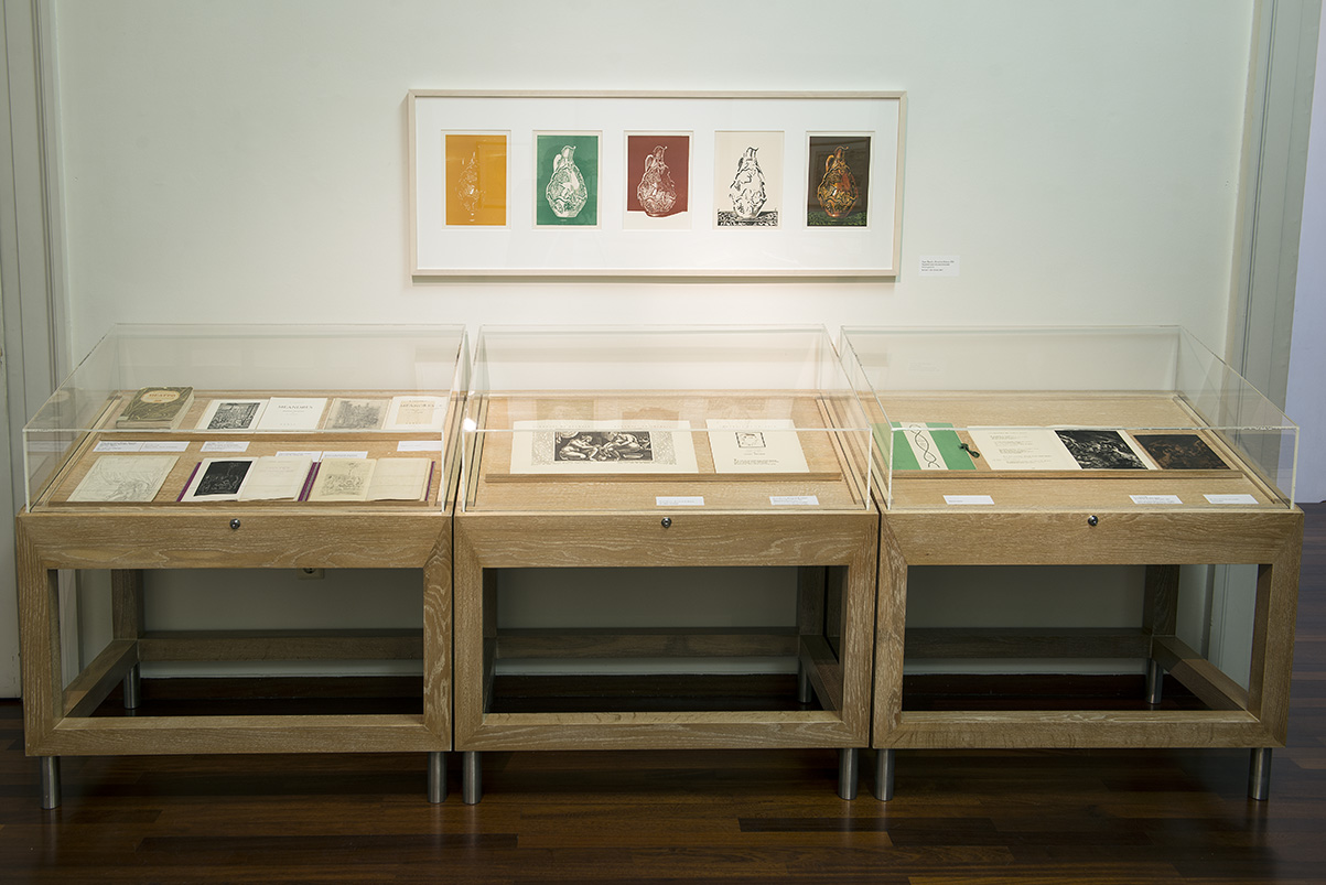 Exhibits in display cases and on the wall.  Section of the exhibition “Dimitris Galanis. The Illustrated Books”