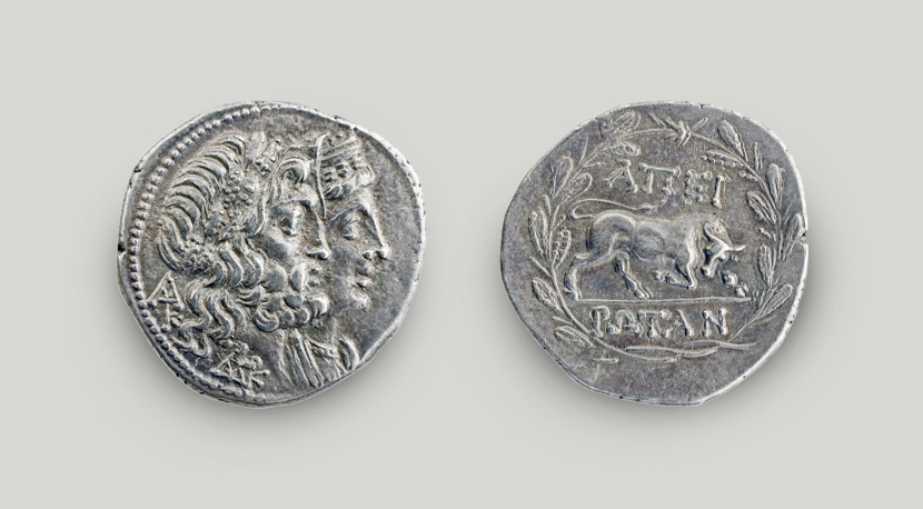 Two sides of silver didrachm of Epirote League. On the obverse the heads of Zeus and Dione, on the reverse bull and the legend APEIROTAN.  Two sides of silver didrachm of the Epirote League