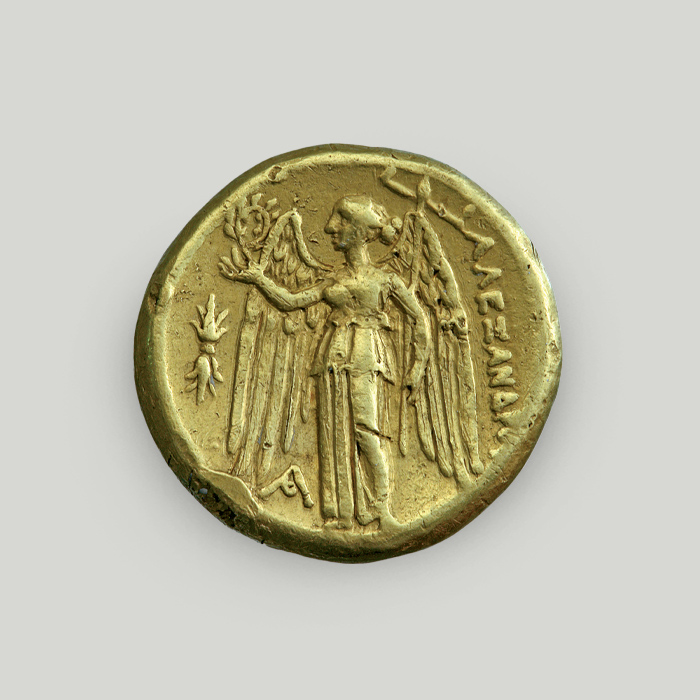 Reverse of gold double stater of Alexander the Great depicting Nike holding wreath and ship mast.  Reverse of gold double stater of Alexander the Great