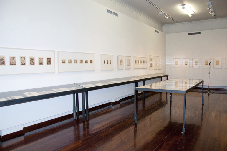 Section of the exhibition with exhibits on the walls and in display cases.  Section of the exhibition “Dimitris Galanis. The Illustrated Books”