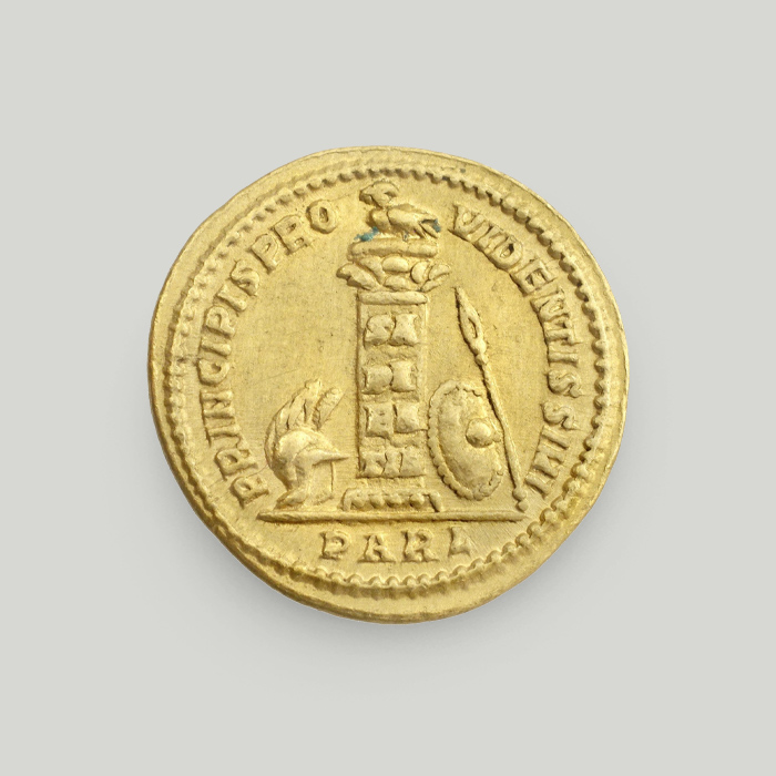 Reverse of gold solidus of Constantine the Great depicting an owl atop a column, a shield, a spear and a helmet.  Reverse of gold solidus of Constantine the Great