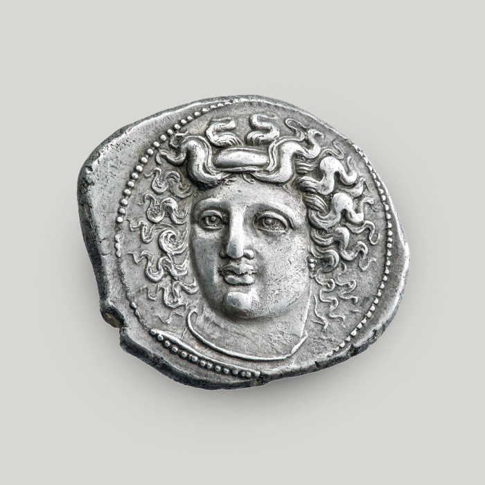 Obverse of the silver didrachm of Larissa depicting the head of nymph Larissa within a circular dotted border.  Obverse of the silver didrachm of Larissa