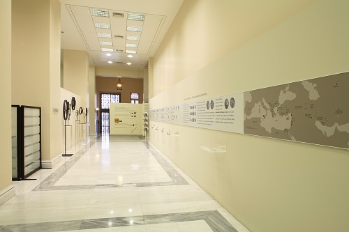 The exhibition area, with coins and works by sculptor Giorgos Lappas, and useful material on the background.  “Ancient Coins in the Alpha Bank Collection. Contemporary Inspiration for the Sculpture of Giorgos Lappas” exhibits