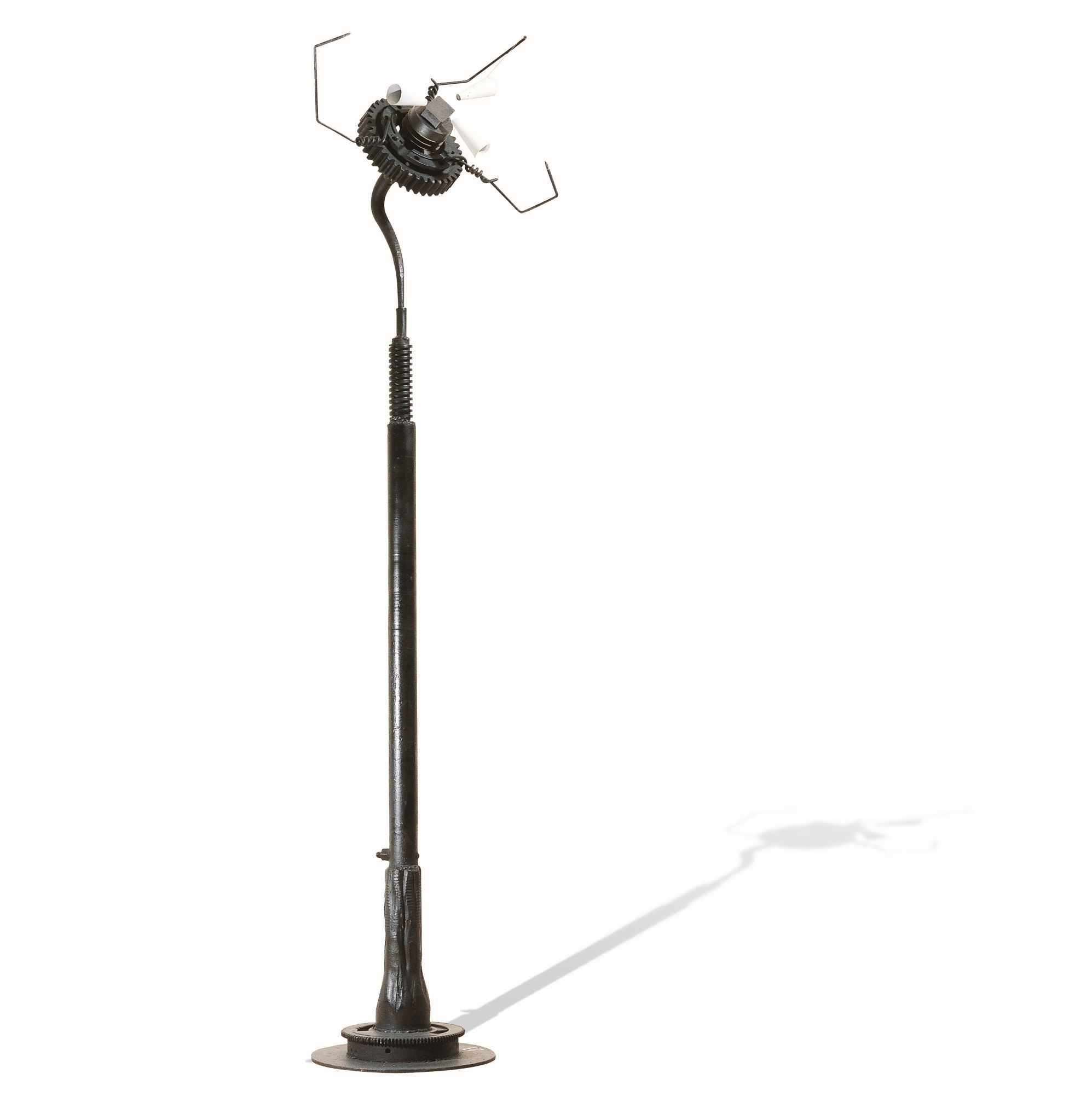 A metal sculpture resembling a flower, made of iron, magnets, cogs and disks. Magnetic Flower by Takis