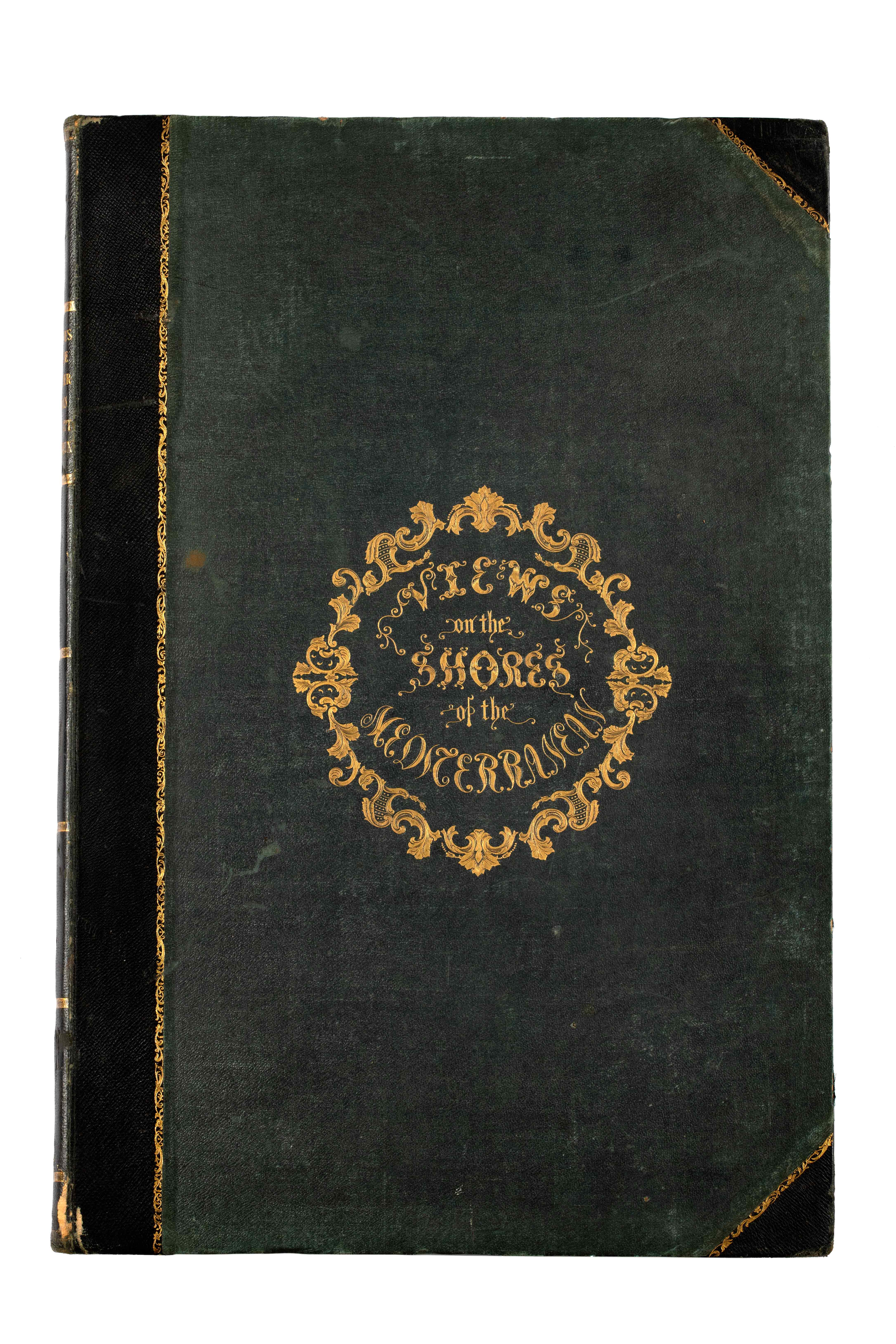 Μαύρο σκληρόδετο εξώφυλλο του βιβλίου Views on the Shores of the Mediterranean με τον τίτλο σε χρυσό.  Εξώφυλλο του βιβλίου Views on the Shores of the Mediterranean