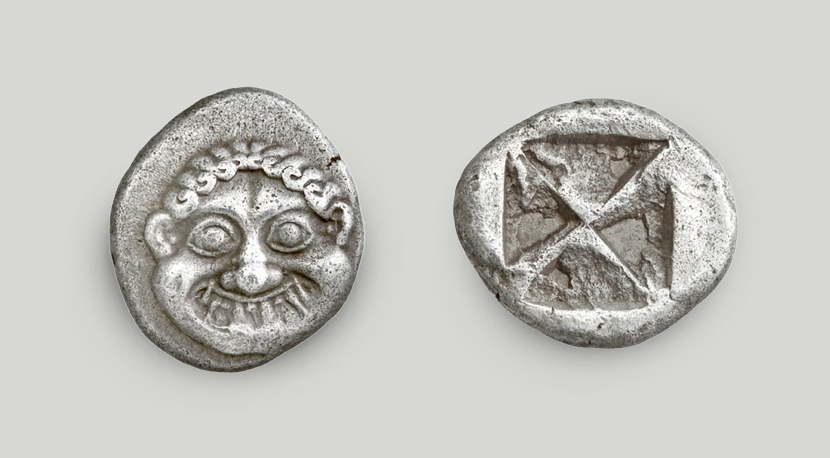 The obverse depicts a stylised Gorgon head. An incuse square is struck on the reverse.  Silver didrachm, Athens, ca 525-520 BCE
