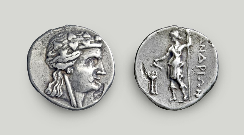 Right: head of Dionysus on the obverse. Left: reverse depicting Dionysus using a cantharus to offer libations before a tripod. The god holds a thyrsus; the legend reads “ANDRION”.  Silver didrachm, Andros