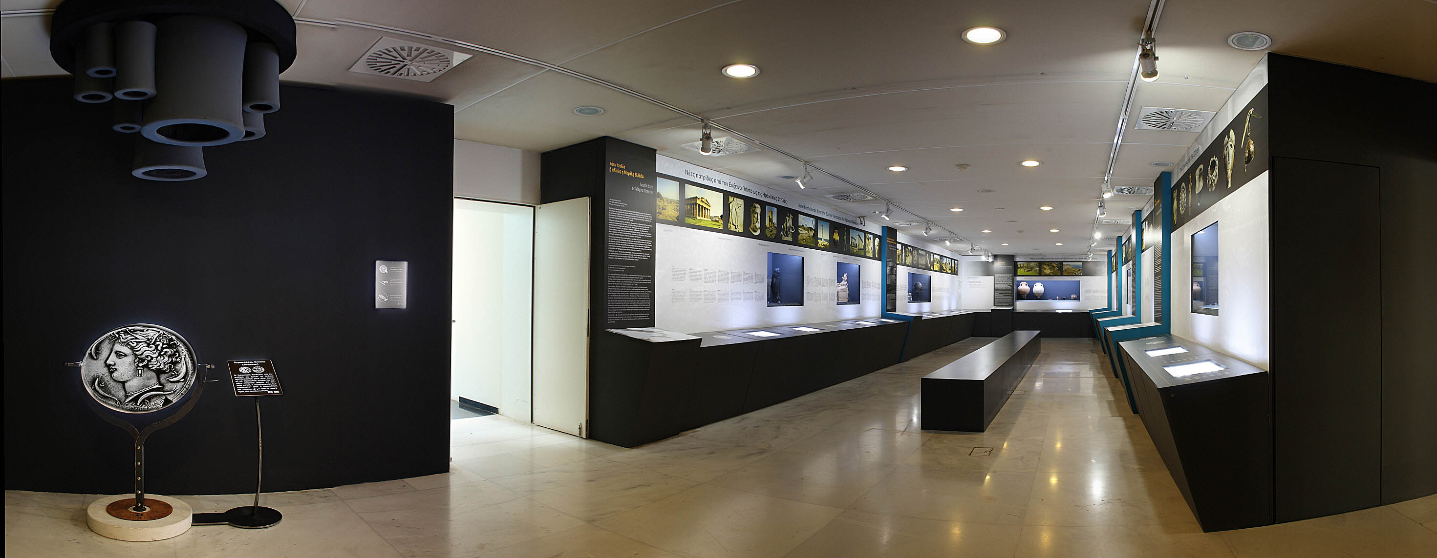 The exhibition area with exhibits in illuminated cases. Exhibits “The Europe of Greece”