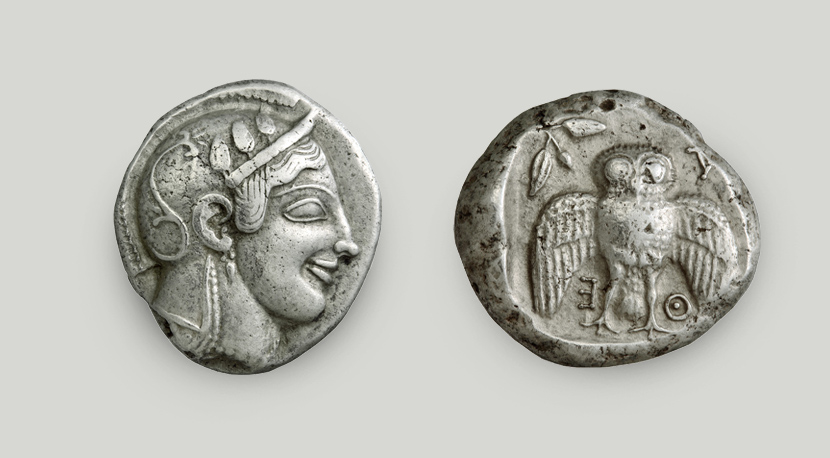 Two sides of Athenian decadrachm. On the obverse Athena’s head in profile, on the reverse owl with spread wings and the legend ATHE. Two sides of Athenian silver decadrachm