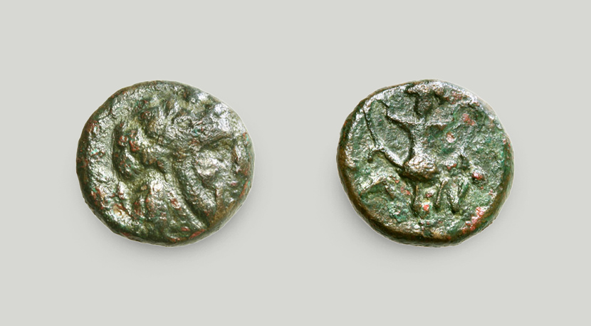 Left: obverse depicting a bearded head of the god Dionysus. Right: a cantharus and the initials A and N on the reverse.  Bronze coin, Andros